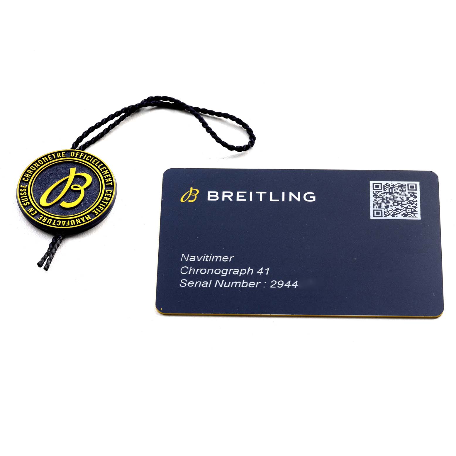 The image shows a Breitling Navitimer A13324 Men
s Stainless Steel Blue Dial A13324 Men
s Stainless Steel Blue Dial Chronograph 41 serial number card alongside a branded tag.