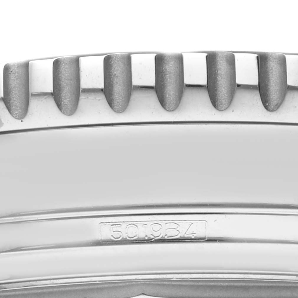 Close-up of the bezel edge, part of the watch case, and serial number on a Breitling Navitimer A13324 Men's Stainless Steel Blue Dial A13324 Men's Stainless Steel Blue Dial watch.