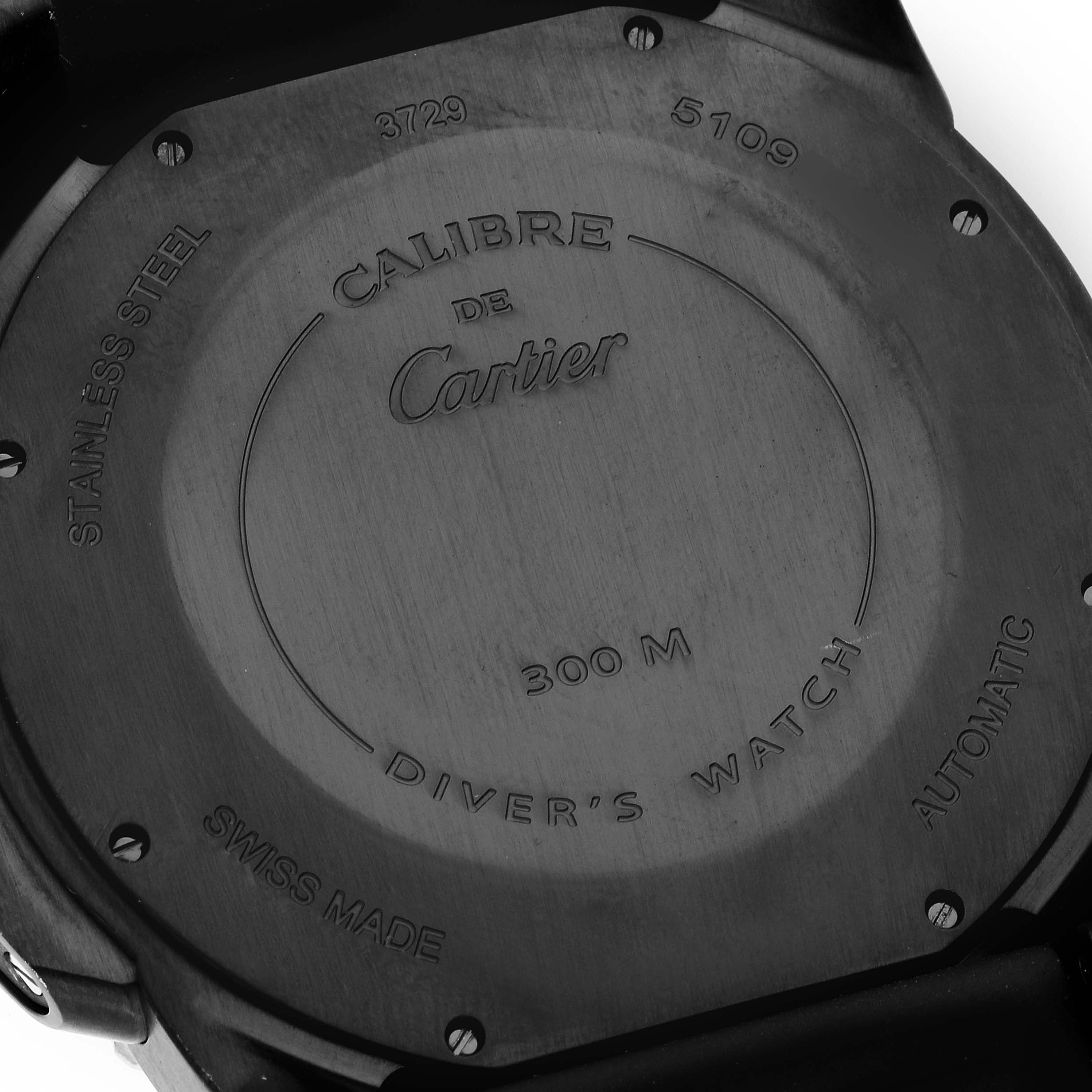 The image shows the back case of a Calibre de Cartier watch by Cartier.