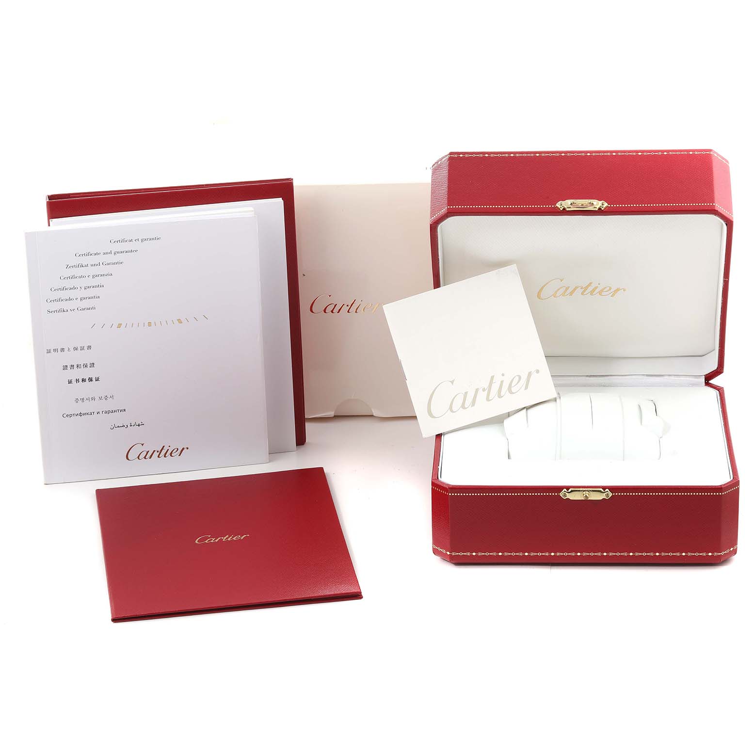 The image shows accessories for a Calibre de Cartier watch by Cartier, including a red box, booklets, and inner packaging.