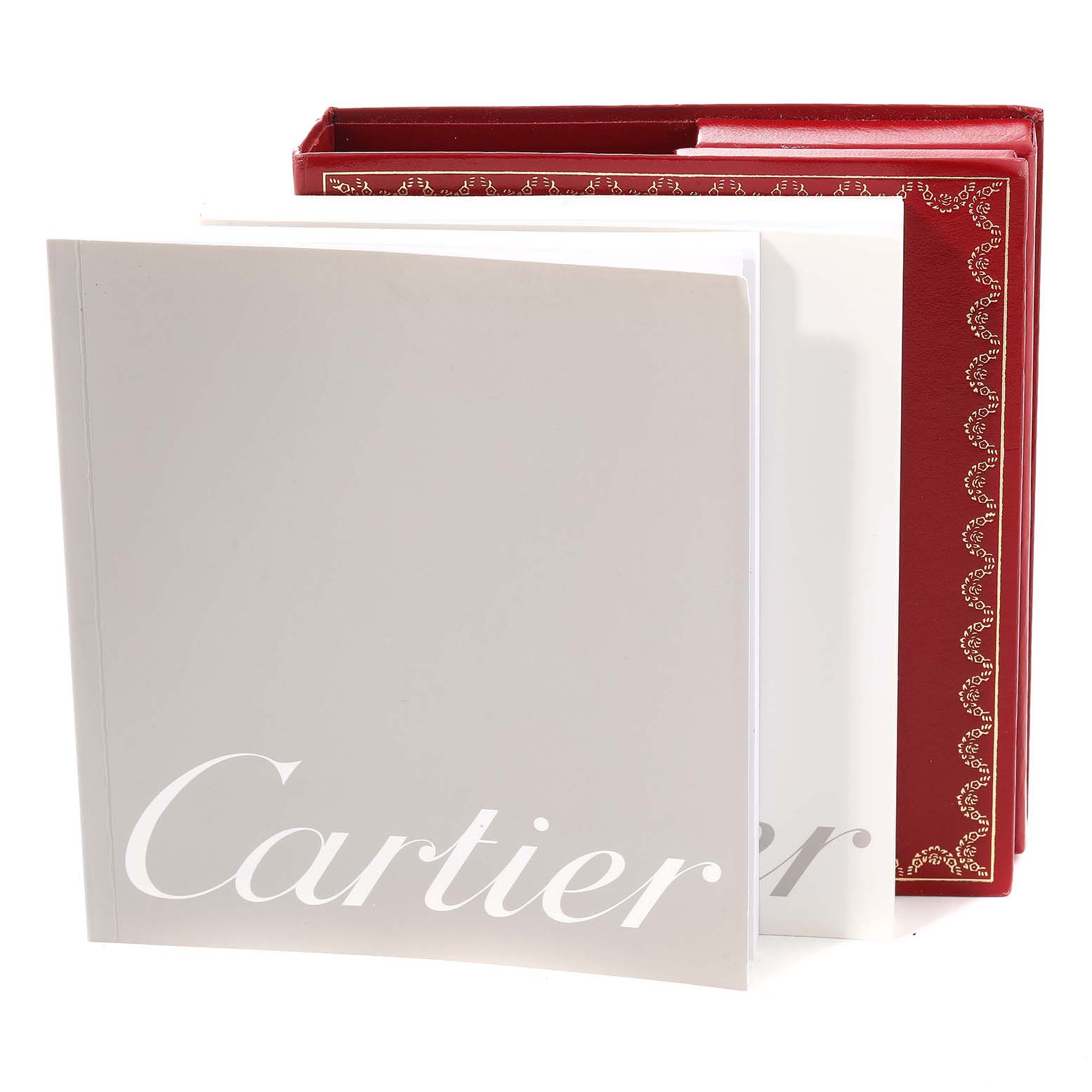 The image shows the instruction manuals and warranty booklet for the Santos model by Cartier.