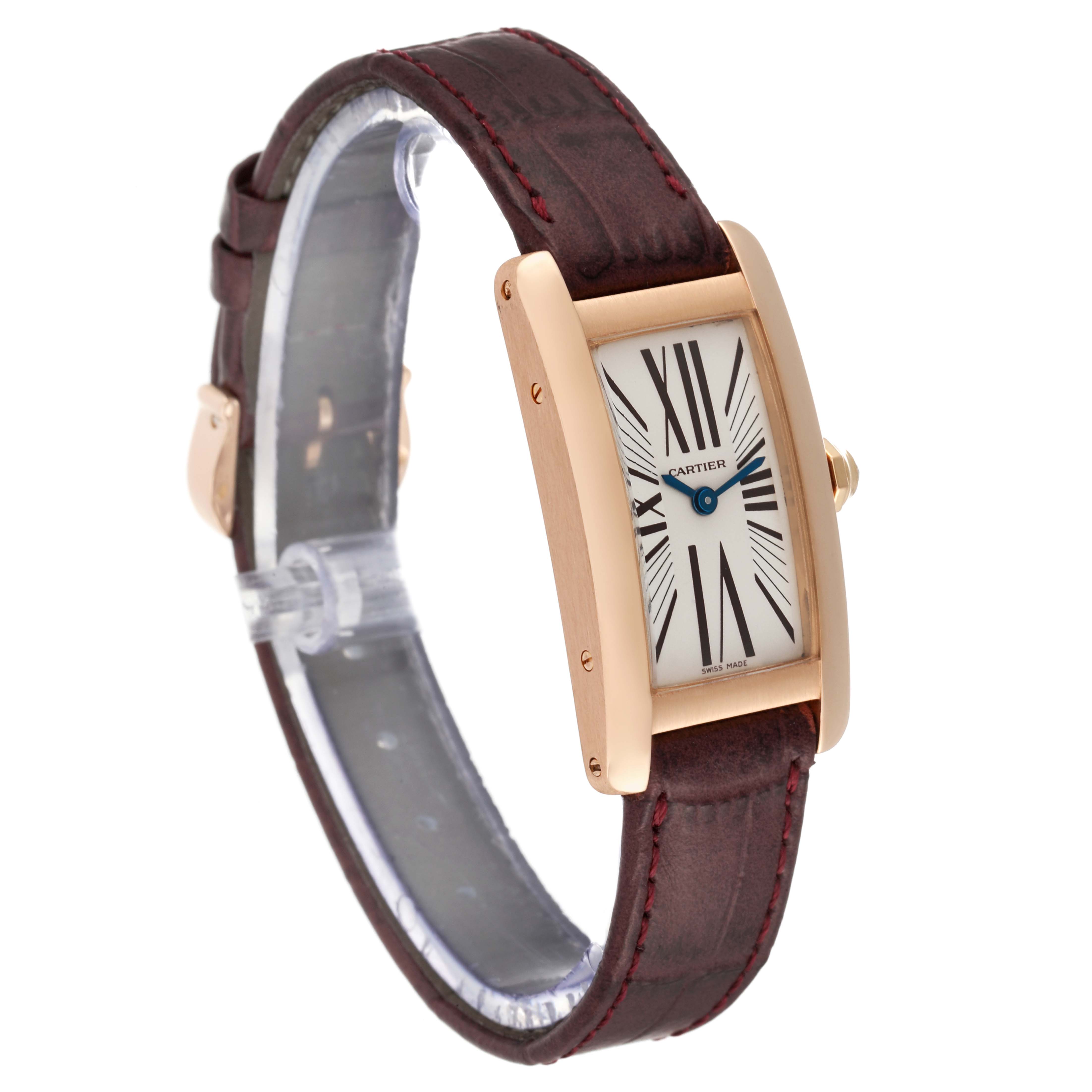 The Tank Americaine by Cartier is shown at a slight angle, highlighting its rectangular face, brown leather strap, and gold-tone case.