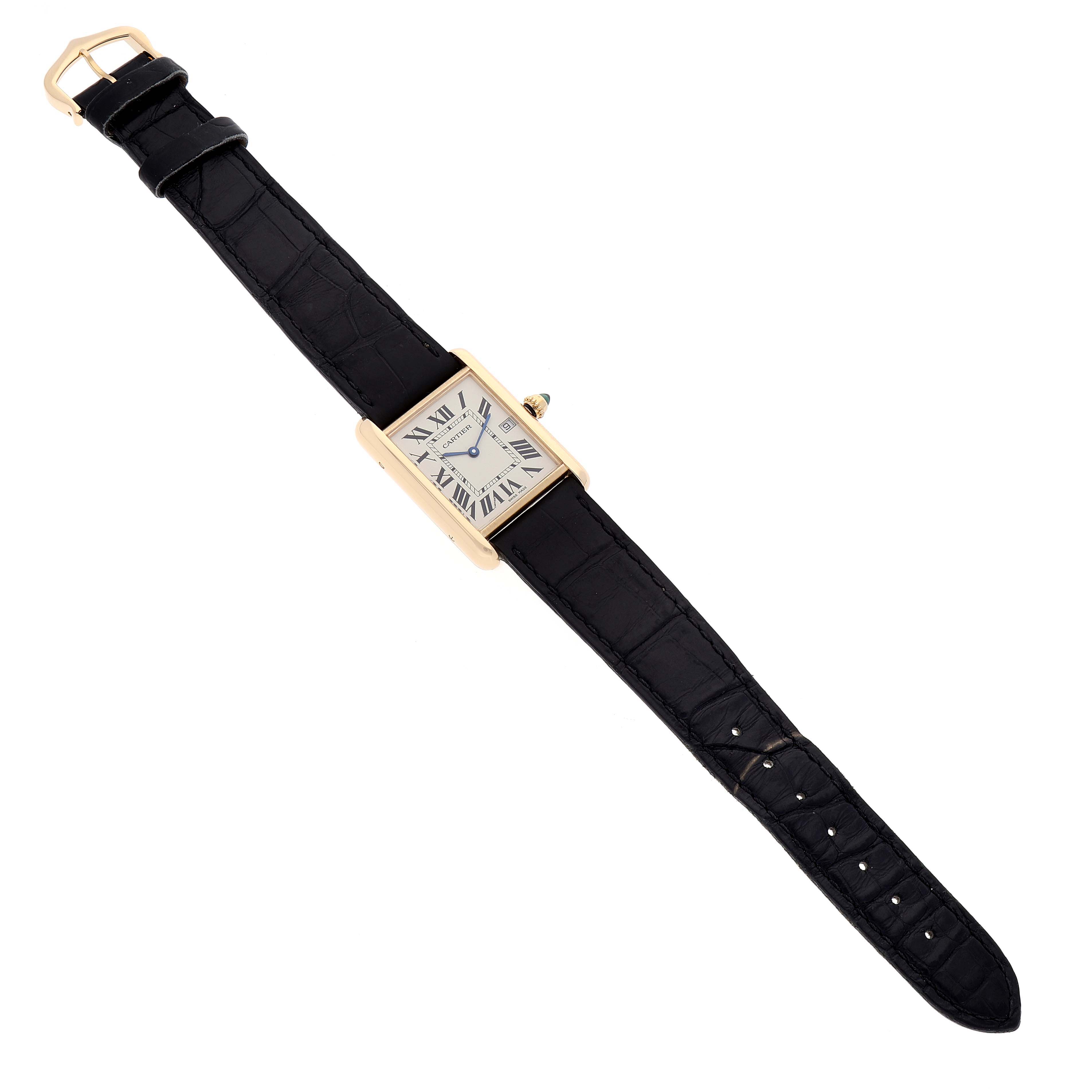 The Tank Louis watch by Cartier is shown lying flat, displaying the face, black leather strap, and gold buckle.