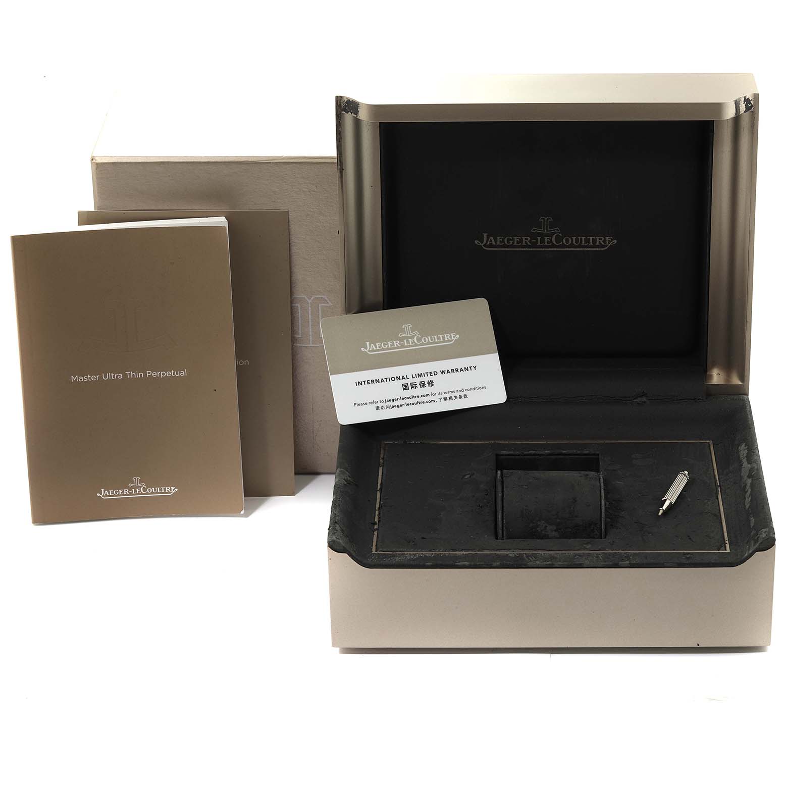 The image shows the packaging and accessories for the Jaeger LeCoultre Master Q1302501 Men
s Rose Gold Silver Dial Q1302501 Men
s Rose Gold Silver Dial Ultra Thin Perpetual watch, including its box, manuals, warranty card, and a tool.