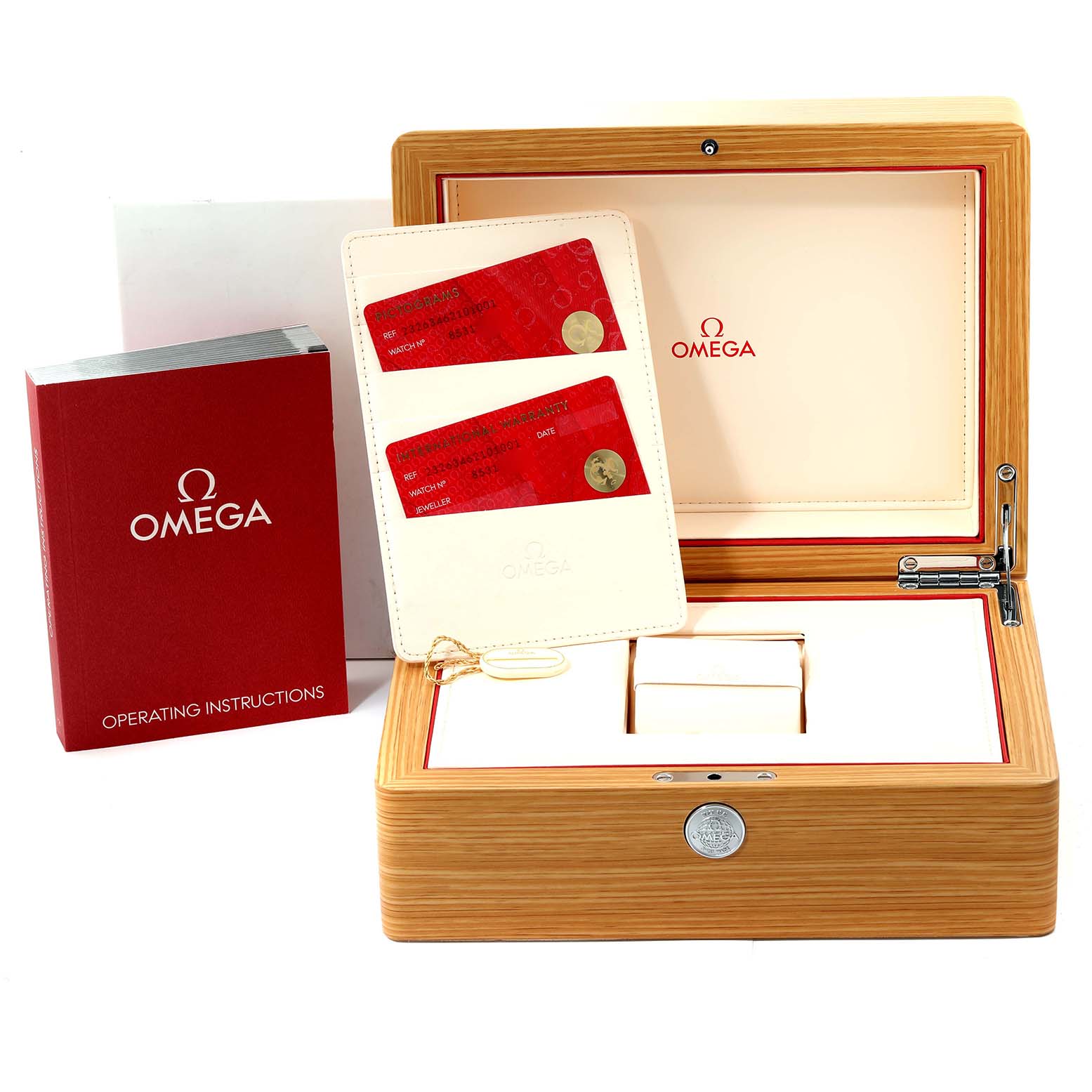 The image shows an Omega Seamaster watch box with a booklet, warranty cards, and accessories from a top-front angle.