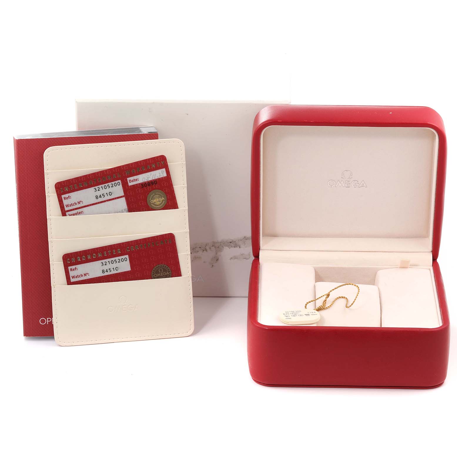 The image shows Omega Speedmaster 3210.52.00 Men
s Stainless Steel Black Dial 3210.52.00 Men
s Stainless Steel Black Dial accessories including the watch box, warranty cards, and cardholder from a front angle.