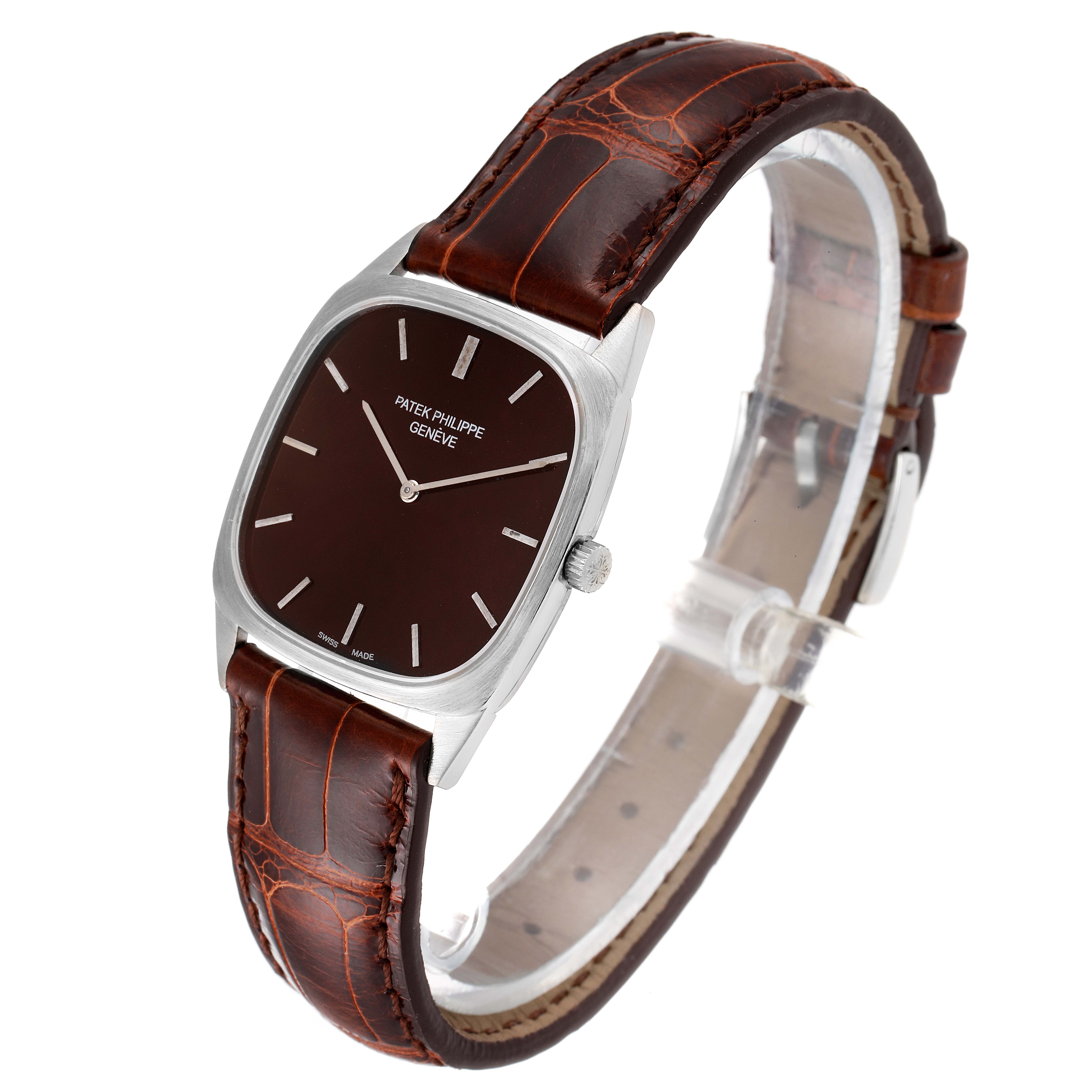 This image shows a side angle view of a Vintage Patek Philippe watch, displaying its brown dial and leather strap.
