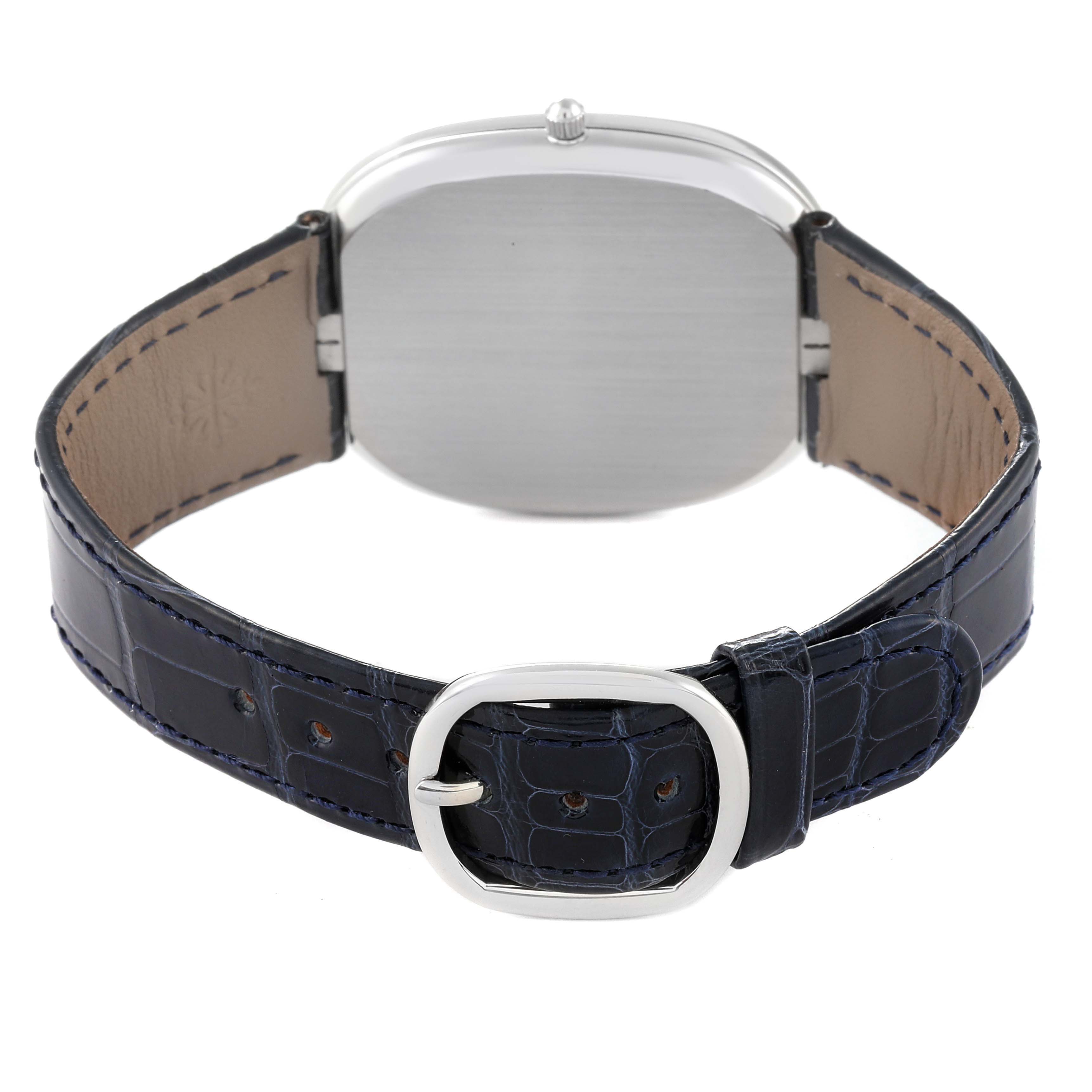 The image shows the back of a Patek Philippe Golden Ellipse 5738P-001 Men's Platinum Blue Dial 5738P-001 Men's Platinum Blue Dial watch and its black leather strap with a buckle.