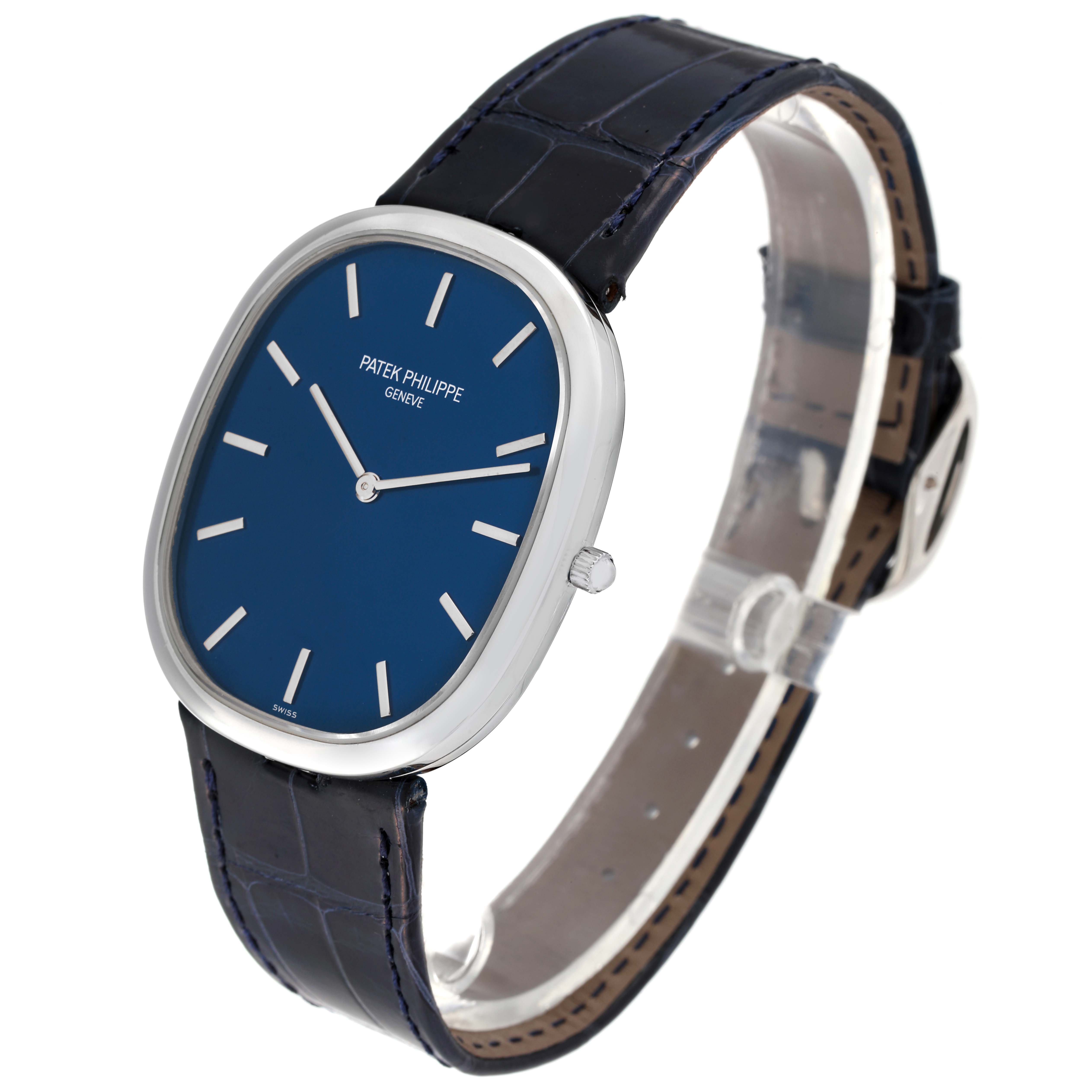 The image shows a Patek Philippe Golden Ellipse 5738P-001 Men's Platinum Blue Dial 5738P-001 Men's Platinum Blue Dial watch at a three-quarter angle, highlighting the blue dial and leather strap.