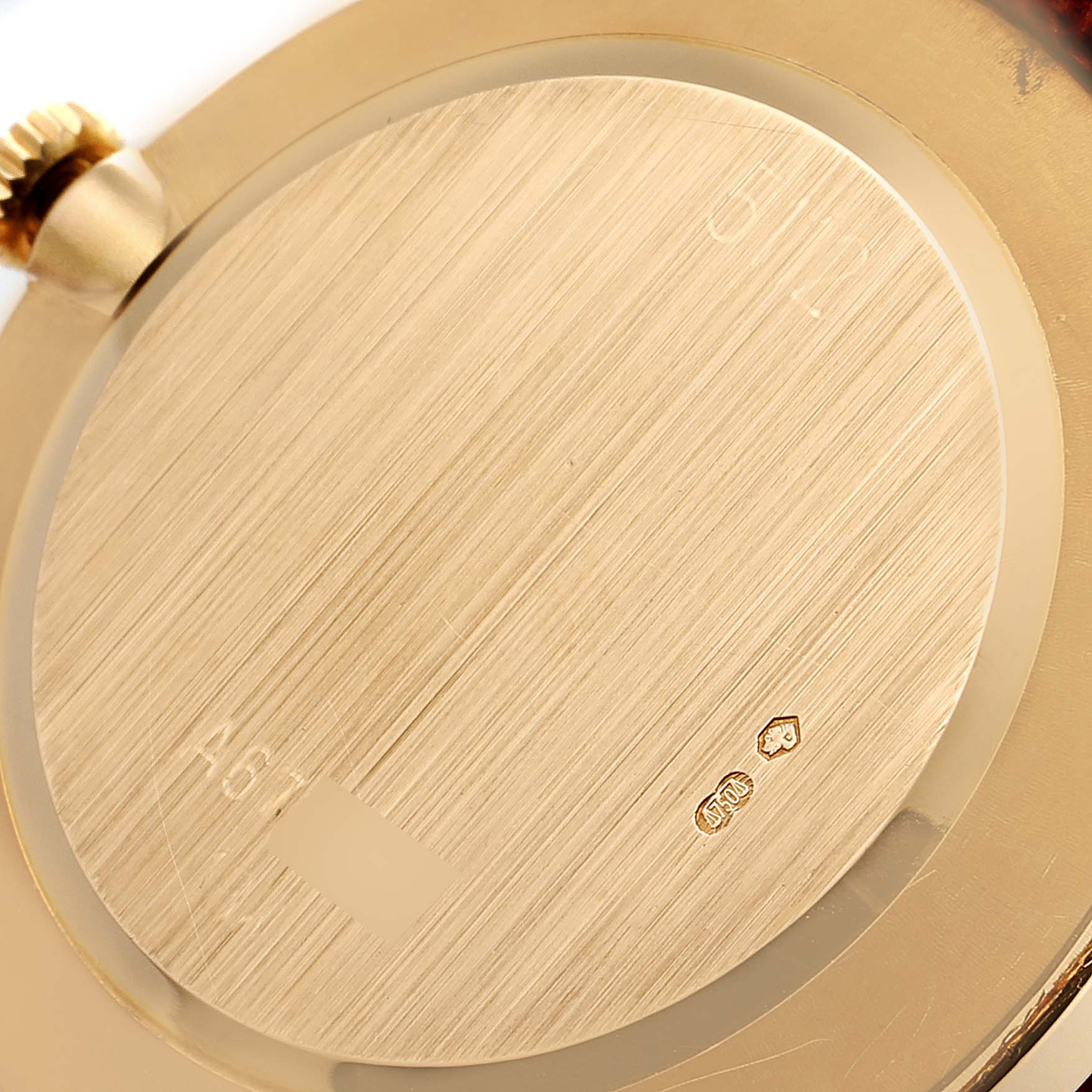The image shows the case back of a Rolex Cellini 5112 Men's Yellow Gold White Dial 5112 Men's Yellow Gold White Dial watch, highlighting its gold finish and engravings.