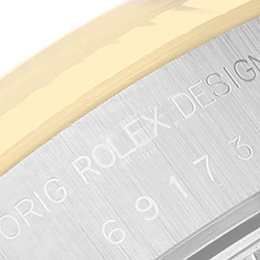 The image shows a close-up of the engraved bezel of a Rolex Datejust 69173 Women's Steel and Gold (two tone) Champagne Dial 69173 Women's Steel and Gold (two tone) Champagne Dial watch. 