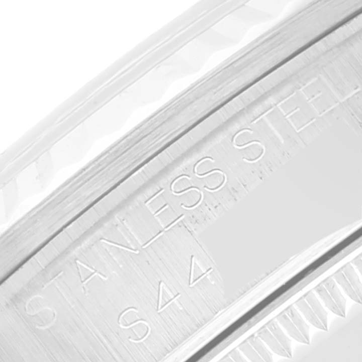 The image shows a close-up view of the case back's inner rim of a Mid-Size Rolex watch, highlighting the stainless steel engraving.