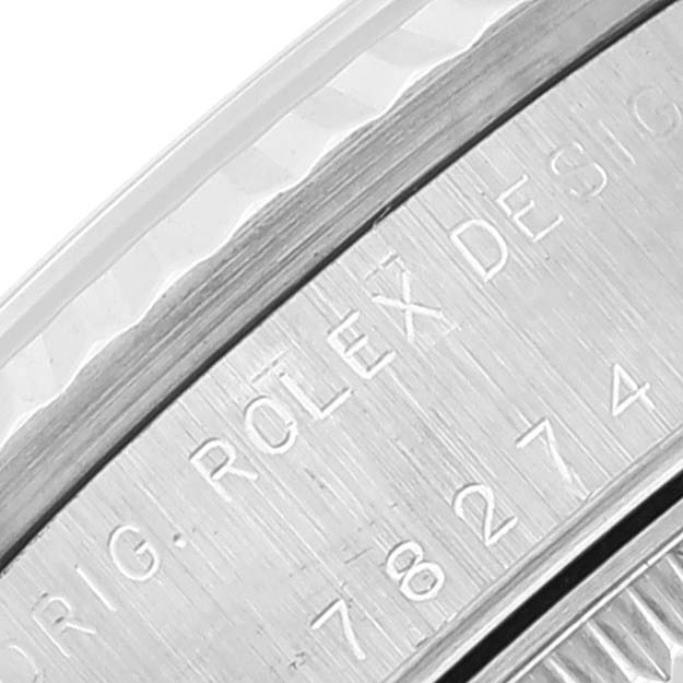 This image shows a close-up of the engraved bezel of a Mid-Size Rolex watch.