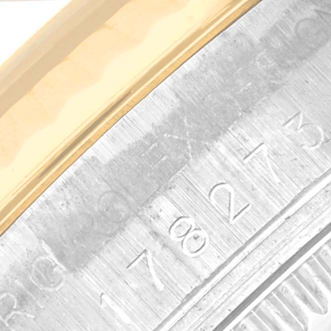 The image shows a close-up of the bezel and part of the engraved casing of a Rolex Mid-Size 178273 Women's Steel and Gold (two tone) Champagne Dial 178273 Women's Steel and Gold (two tone) Champagne Dial model watch.