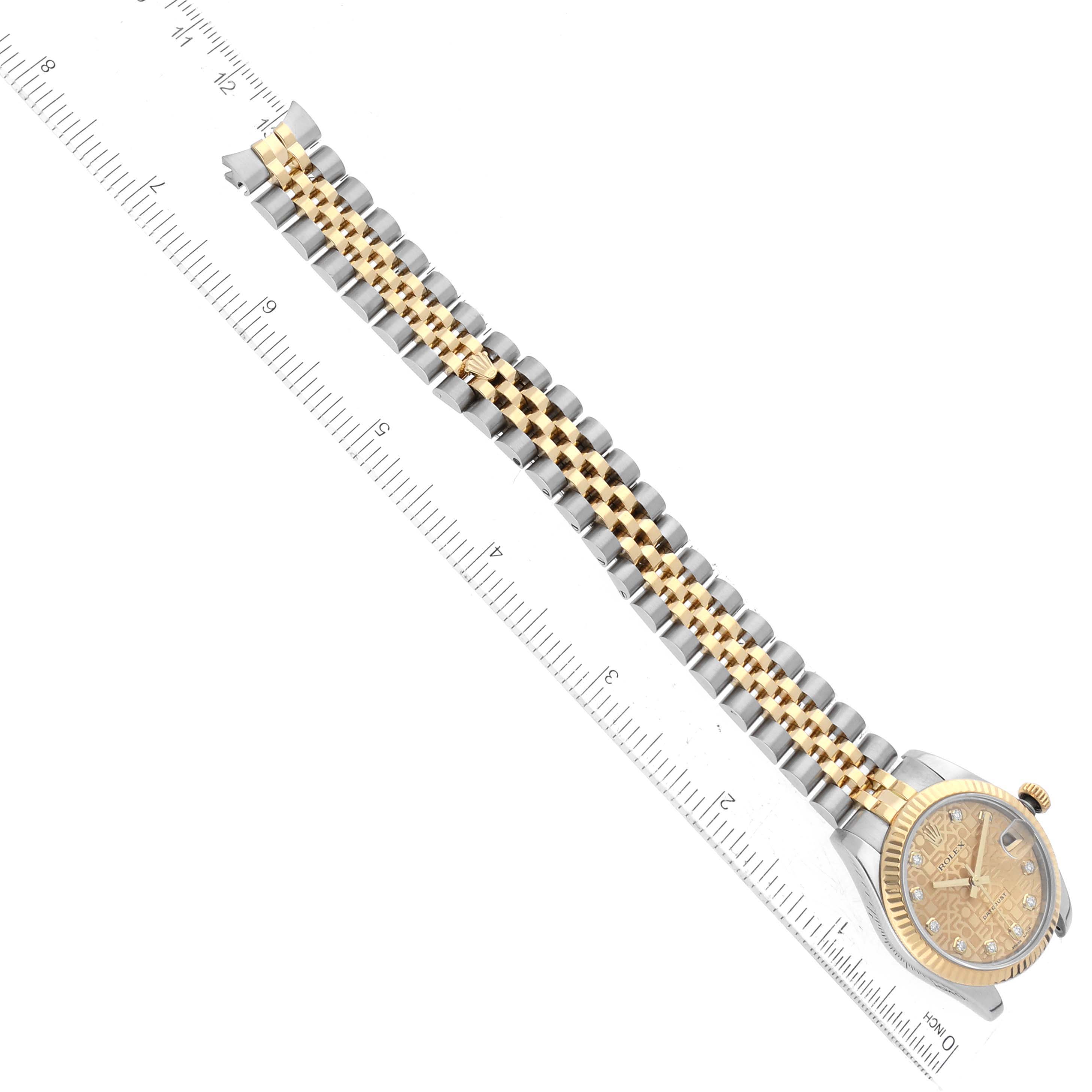 The image shows a Rolex Mid-Size 178273 Women's Steel and Gold (two tone) Champagne Dial 178273 Women's Steel and Gold (two tone) Champagne Dial watch laying flat, highlighting the face, bezel, and two-tone bracelet next to a ruler for scale.