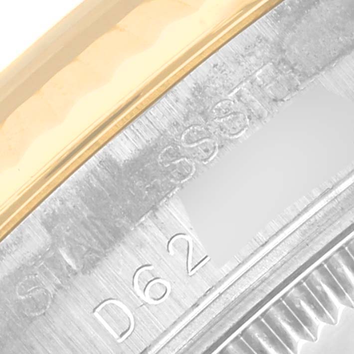 This close-up image shows the side and partial bezel of a Mid-Size Rolex watch, highlighting its stainless steel and gold construction.