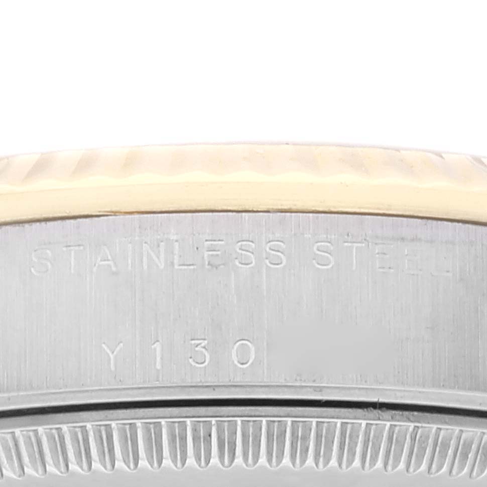 This image shows a close-up of the side of a Rolex Mid-Size 78273 Women
s Steel and Gold (two tone) Silver Dial 78273 Women
s Steel and Gold (two tone) Silver Dial stainless steel watch case, featuring the engraving "STAINLESS STEEL" and a partial serial number.