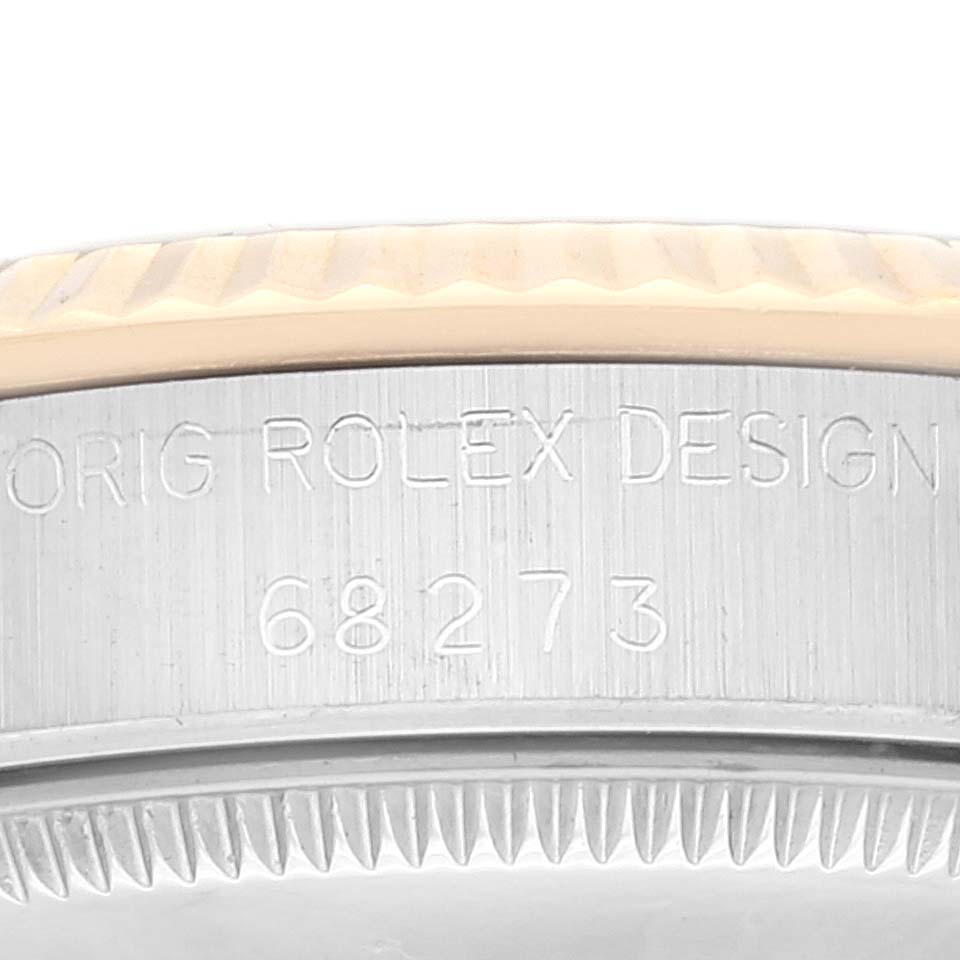 This image shows a close-up of the model number and the bezel of a Rolex Mid-Size 68273 Women's Stainless Steel Champagne Dial 68273 Women's Stainless Steel Champagne Dial watch.