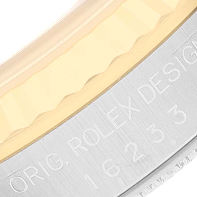 This close-up image shows a portion of the bezel and case of a Rolex Datejust 16233 Men's Steel and Gold (two tone) Champagne Dial 16233 Men's Steel and Gold (two tone) Champagne Dial watch, highlighting the "ORIG. ROLEX DESIGN" engraving.