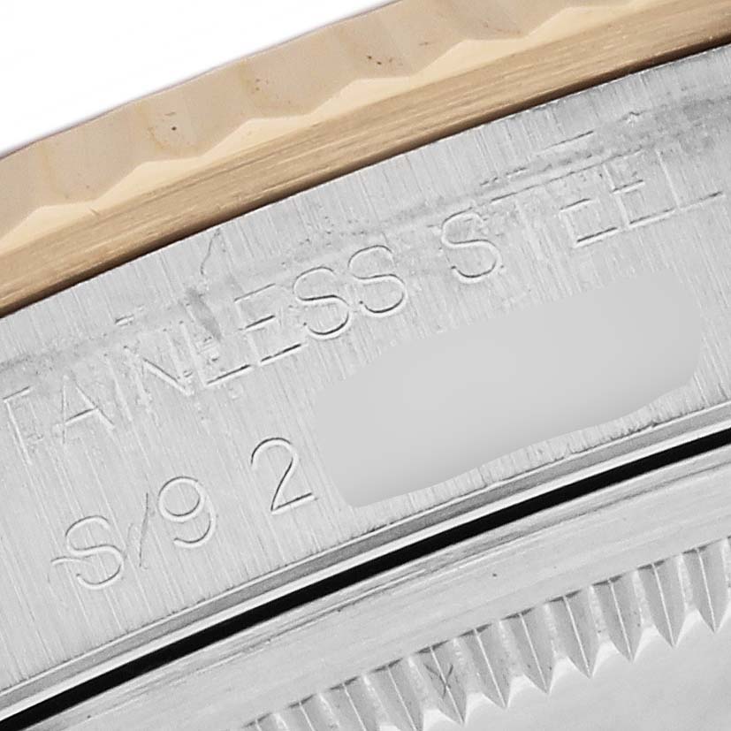 This image shows a close-up of the engraved text on the case side of a Rolex Datejust 16233 Men's Steel and Gold (two tone) Black Dial 16233 Men's Steel and Gold (two tone) Black Dial watch emphasizing the stainless steel material.
