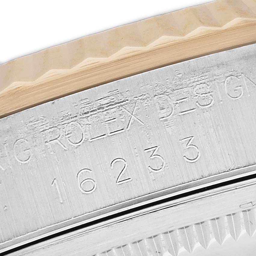This image shows a close-up of the bezel and engraved Rolex branding on the Datejust model by Rolex.