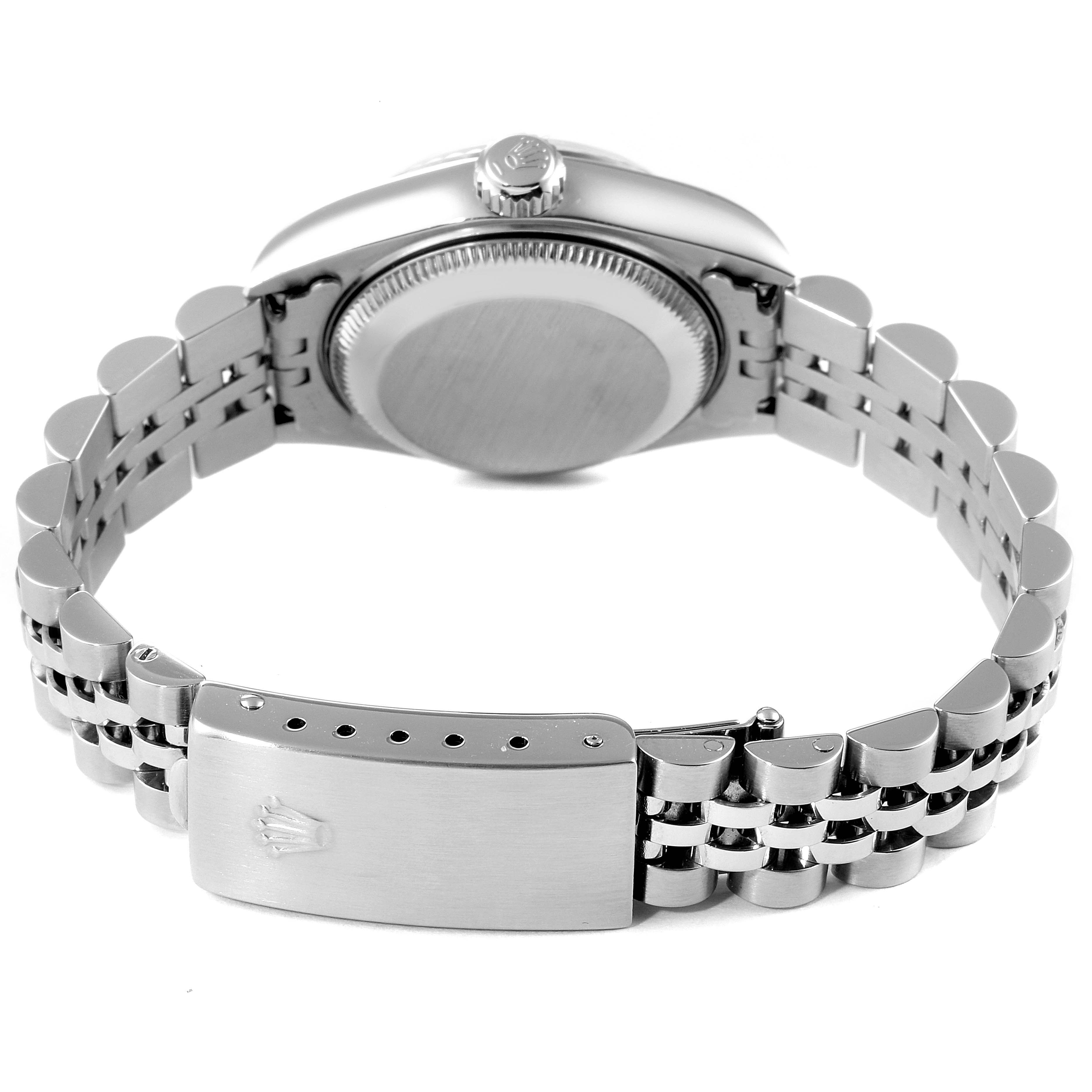 The image shows the back view of a Datejust model Rolex, highlighting the case back, crown, and bracelet with the clasp.