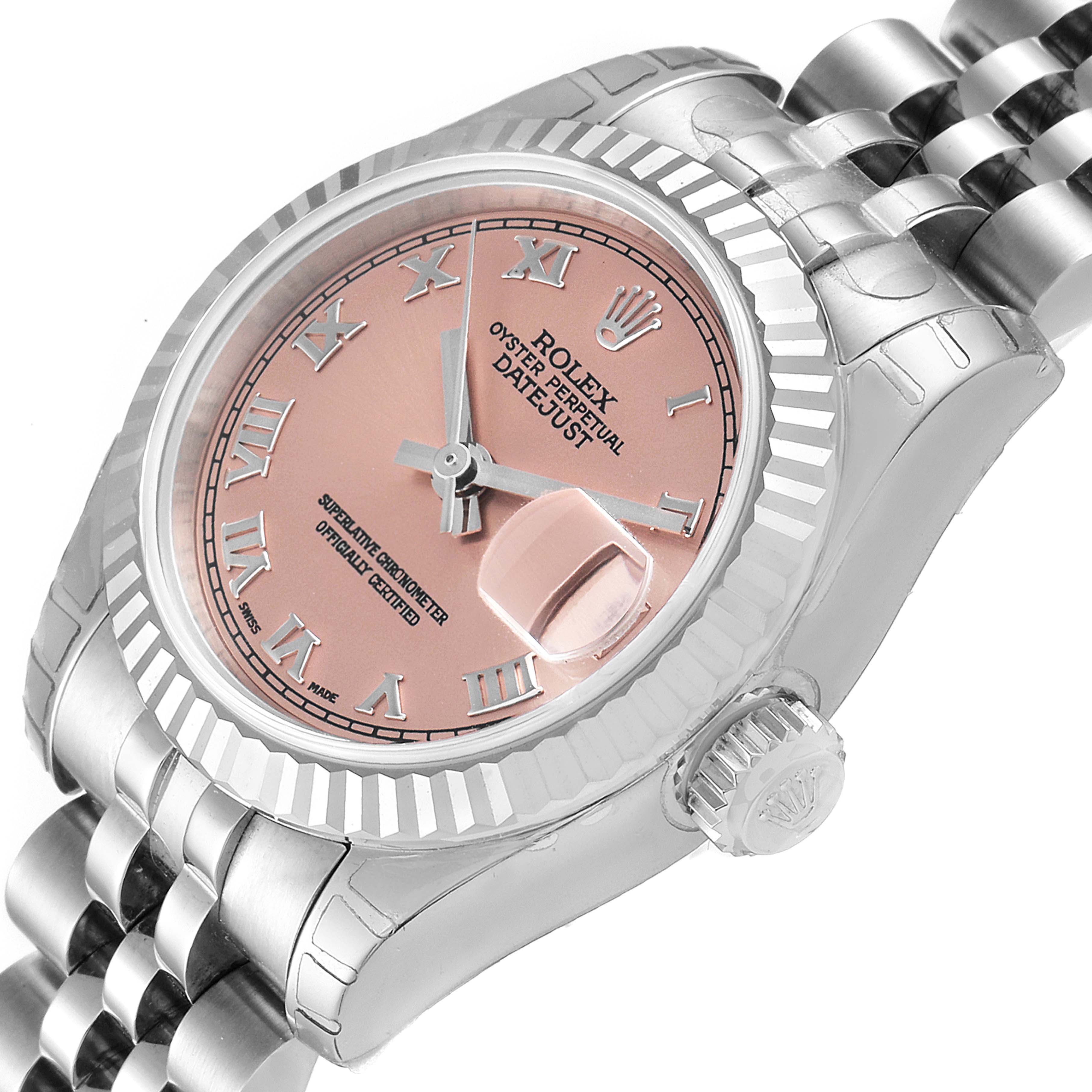 The image shows a side view angle of a Rolex Datejust 179174 Women's Stainless Steel Pink Dial 179174 Women's Stainless Steel Pink Dial watch, displaying its pink dial, fluted bezel, and part of its Jubilee bracelet.