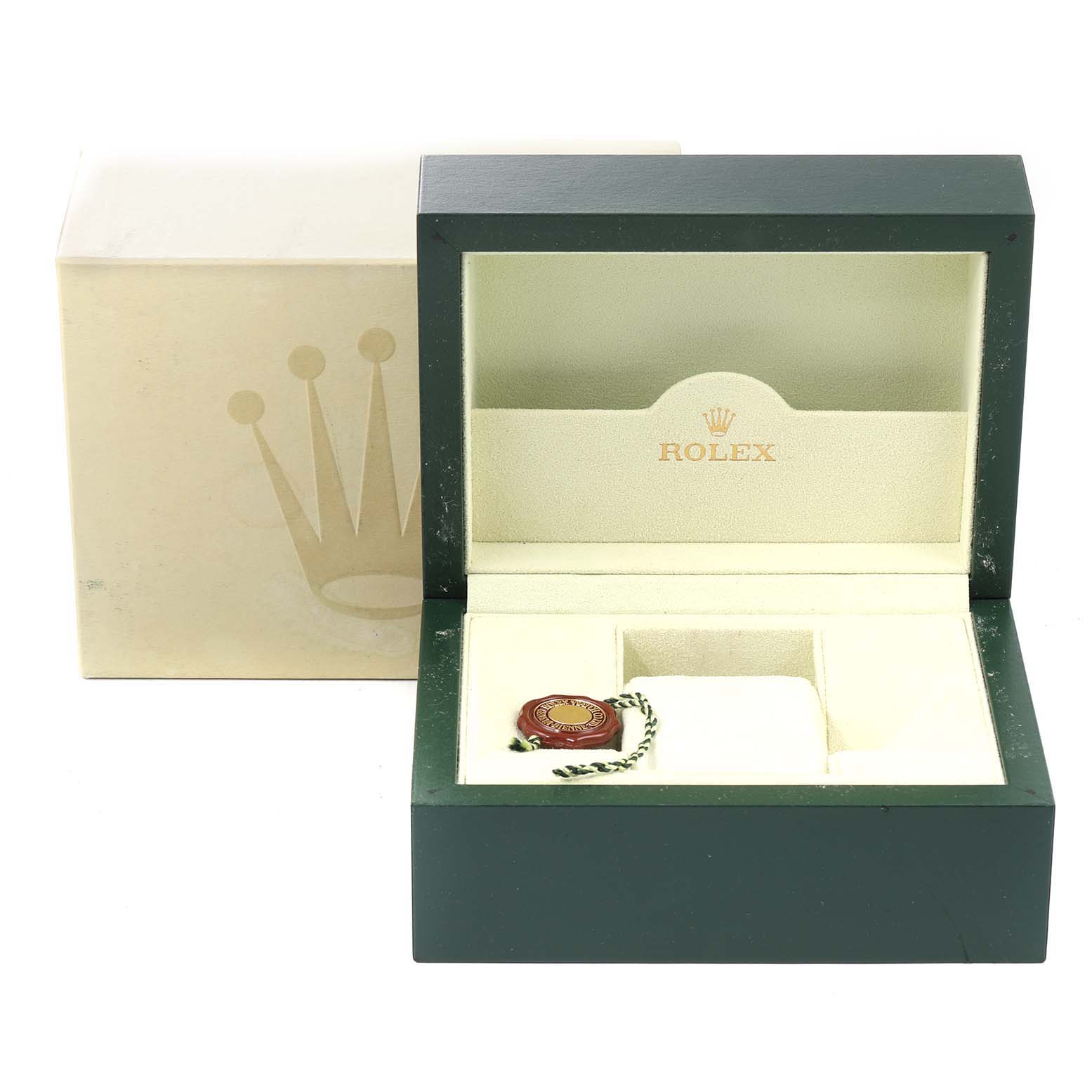 This image shows an open Rolex watch box for a Datejust model, with its tag inside and the outer packaging visible.