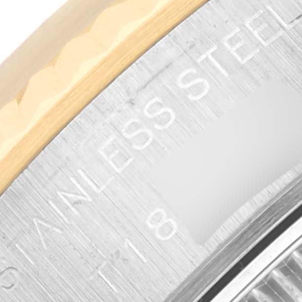 This close-up image shows part of the metal bezel and case back of a Rolex Datejust 69173 Women's Steel and Gold (two tone) Champagne Dial 69173 Women's Steel and Gold (two tone) Champagne Dial watch with the "STAINLESS STEEL" engraving visible.
