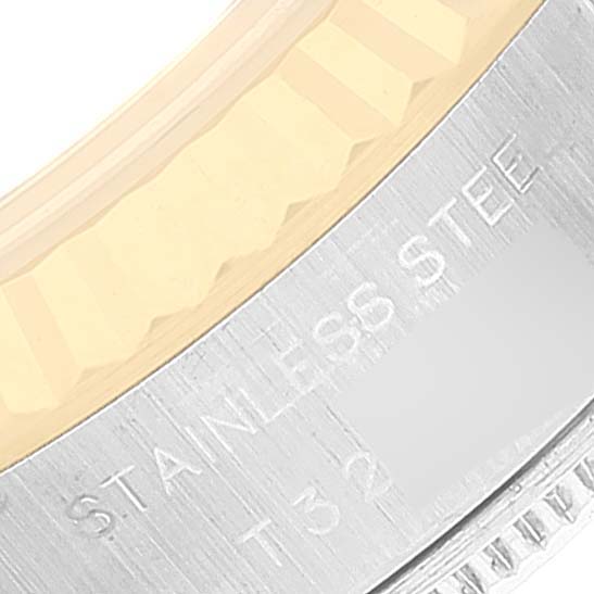 This image shows an angled view of the bezel and case back of a Rolex Datejust 69173 Women's Steel and Gold (two tone) Grey Dial 69173 Women's Steel and Gold (two tone) Grey Dial watch, displaying the engraving "STAINLESS STEEL."