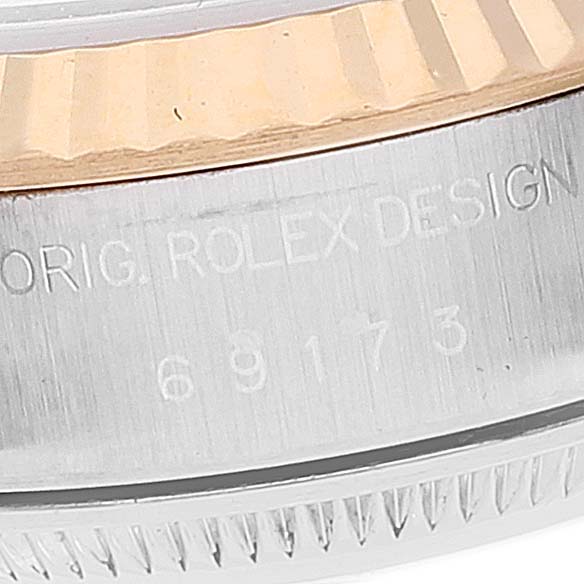 The image shows a close-up view of the bezel and case side of a Rolex Datejust 69173 Women
s Steel and Gold (two tone) White Dial 69173 Women
s Steel and Gold (two tone) White Dial watch, including part of the model number and "ORIG. ROLEX DESIGN" text.
