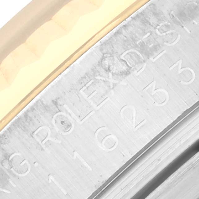 This image shows a close-up of the engraved markings on the inner bezel of a Rolex Datejust 116233 Men's Steel and Gold (two tone) White Dial 116233 Men's Steel and Gold (two tone) White Dial watch.