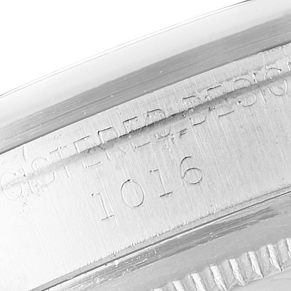 The image shows a close-up angle of the side case of a Rolex Vintage Collection 1016 Men's Stainless Steel Black Dial 1016 Men's Stainless Steel Black Dial watch with the model number 1016 engraved.