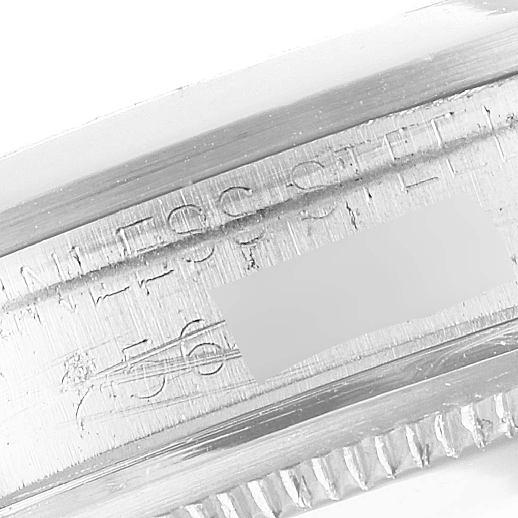 The image shows a close-up of the inner case and bezel teeth of a Vintage Collection model by Rolex, highlighting the "STAINLESS STEEL" engraving.
