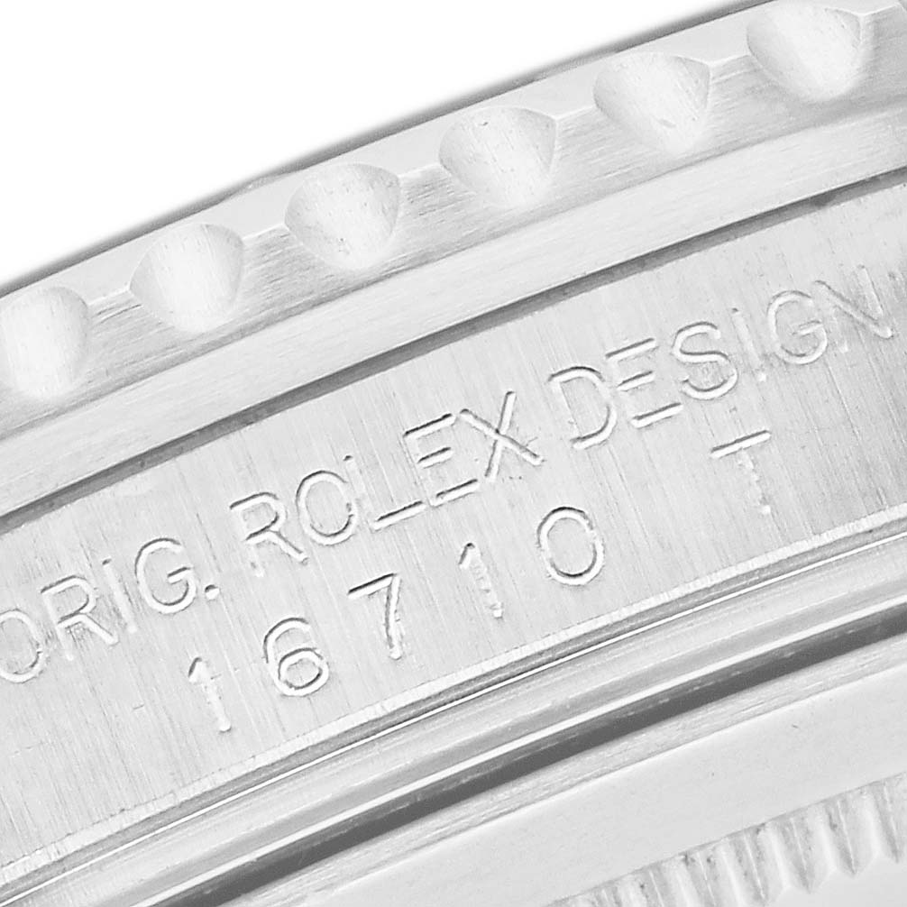 This close-up shot of the Rolex GMT-Master 16710 Men's Stainless Steel Black Dial 16710 Men's Stainless Steel Black Dial shows its model number "16710" engraved on the case side.