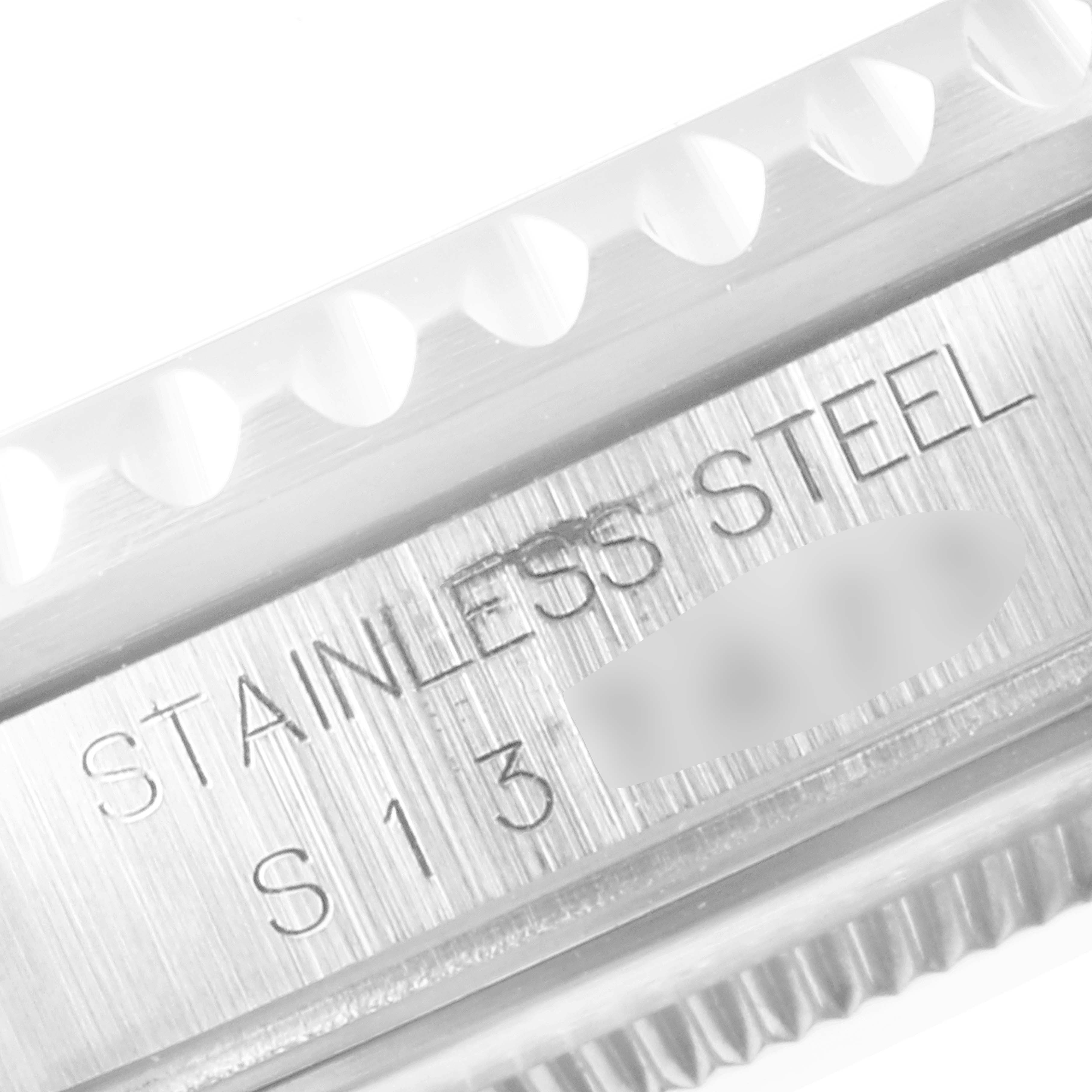 This close-up image shows the stainless steel bezel of a Rolex GMT-Master 16710 Men
s Stainless Steel Black Dial 16710 Men
s Stainless Steel Black Dial watch.