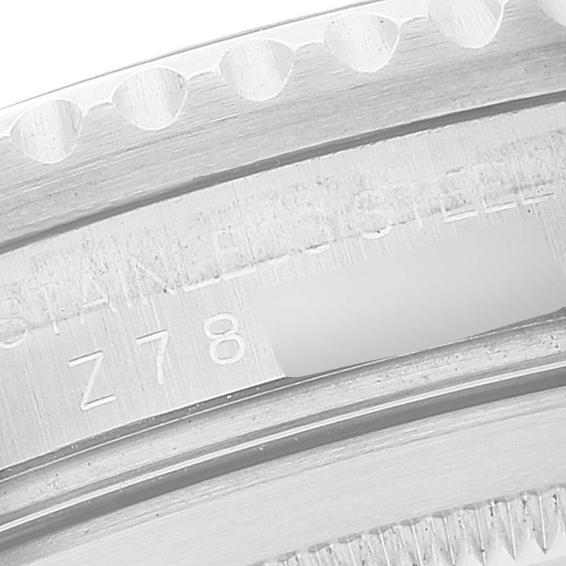 This close-up image shows the side view of the engraved serial number and part of the bezel of the Rolex GMT-Master 16710 Men
s Stainless Steel Black Dial 16710 Men
s Stainless Steel Black Dial watch.