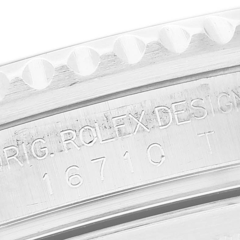 This image shows a close-up of the bezel and case side of a Rolex GMT-Master 16710 Men's Stainless Steel Black Dial 16710 Men's Stainless Steel Black Dial model, featuring engraved details.