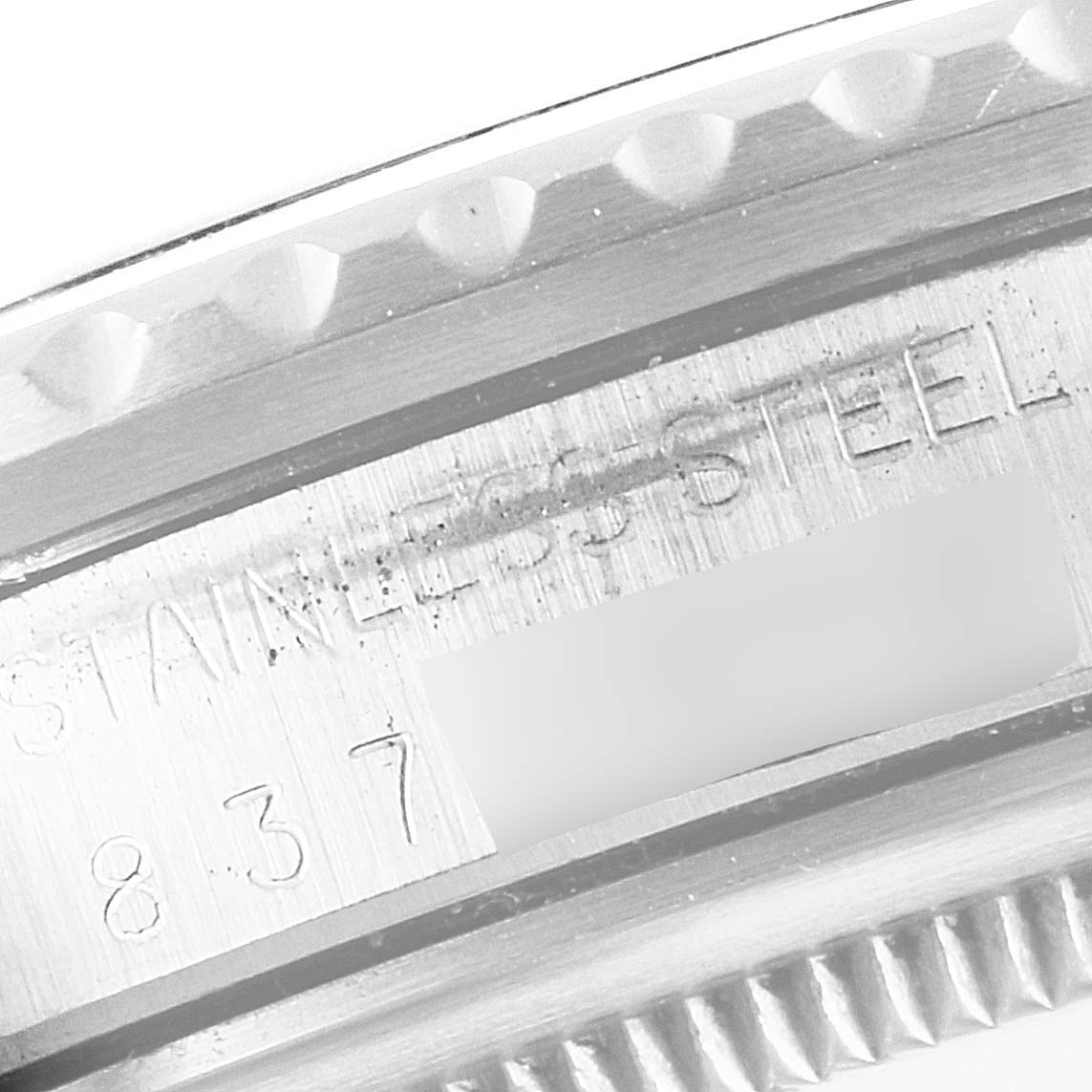 This image shows a close-up of the stainless steel case back and serial number of a Vintage Collection Rolex watch.