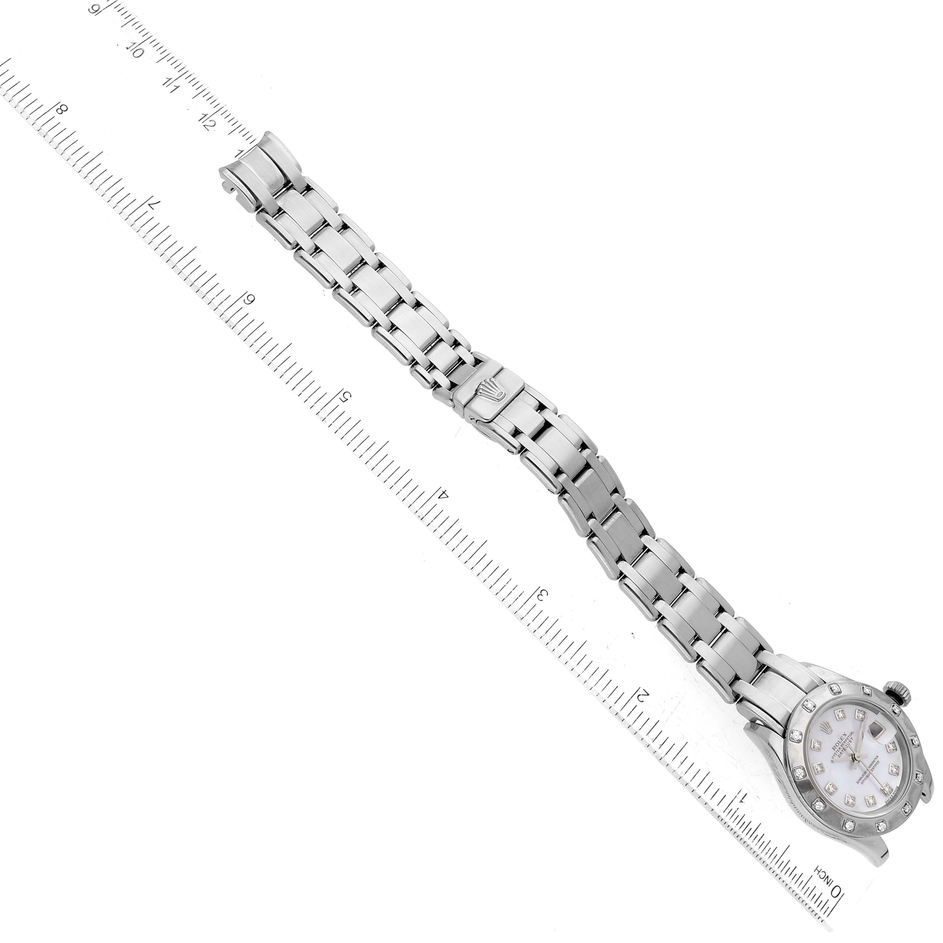 This image shows a Rolex Pearlmaster 80319 Women's White Gold Mother of Pearl Dial 80319 Women's White Gold Mother of Pearl Dial watch laid flat next to a ruler, displaying the bracelet and face.