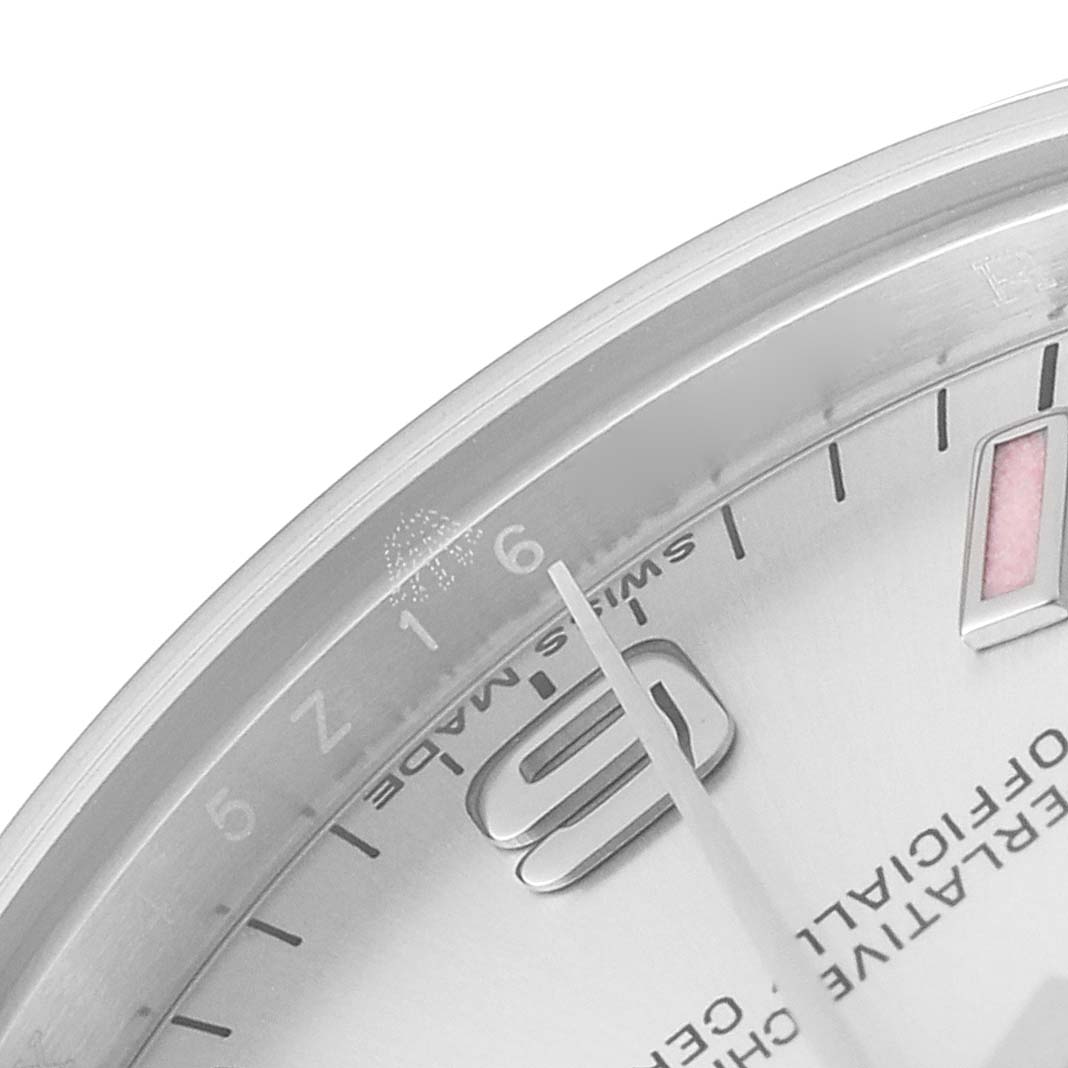 This close-up of a Rolex Mid-Size 177200 Women
s Stainless Steel Silver Dial 177200 Women
s Stainless Steel Silver Dial watch shows the dial
s corner with the 9 marker, minute markers, and the words "SWISS MADE."