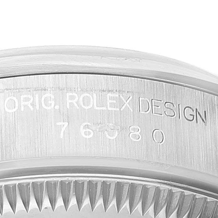 This image shows a close-up of the side engraving on the bezel of a Rolex Oyster Perpetual 76080 Women's Stainless Steel Blue Dial 76080 Women's Stainless Steel Blue Dial watch.