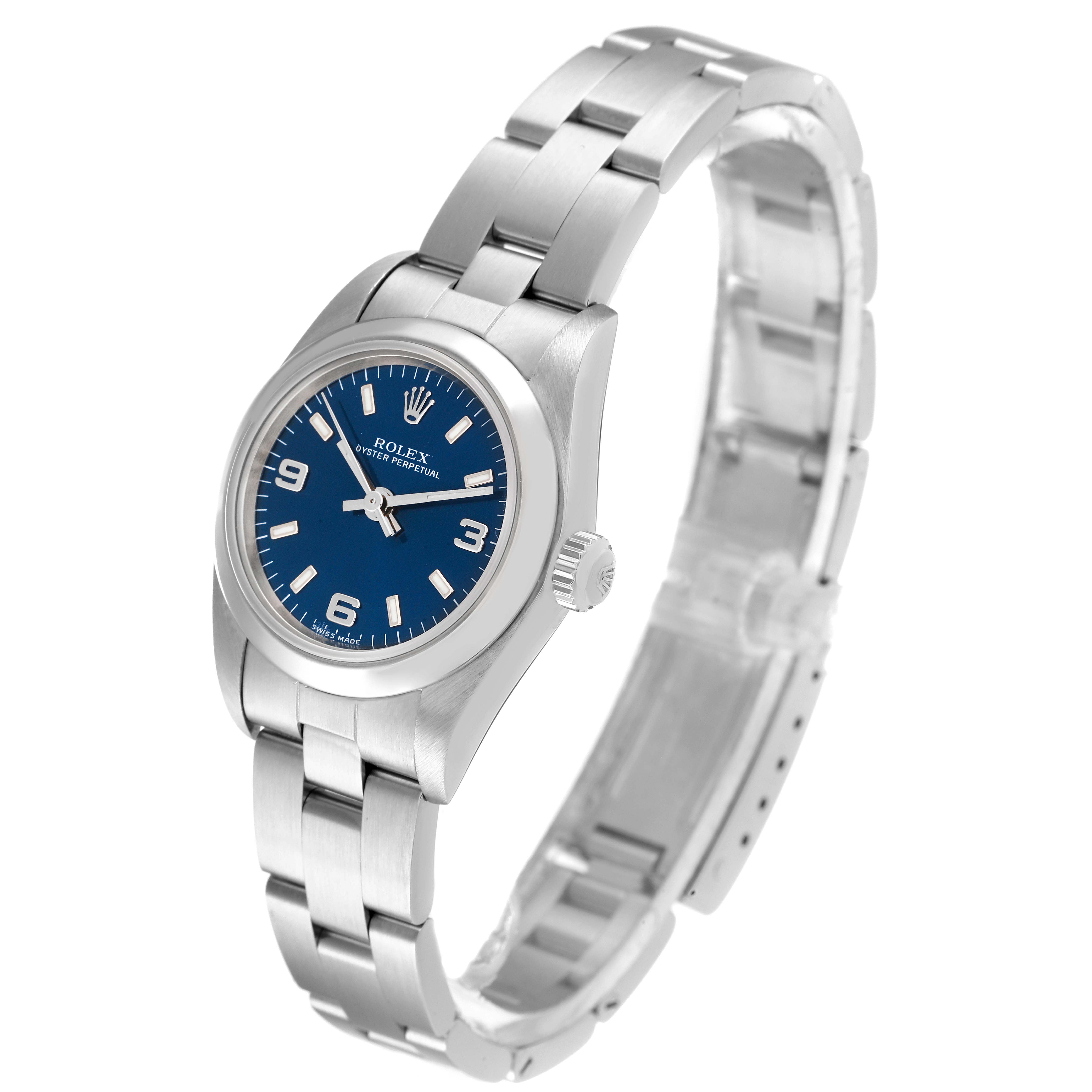This Rolex Oyster Perpetual 76080 Women's Stainless Steel Blue Dial 76080 Women's Stainless Steel Blue Dial watch is shown at a three-quarter angle, highlighting its blue dial, hour markers, and stainless steel bracelet.