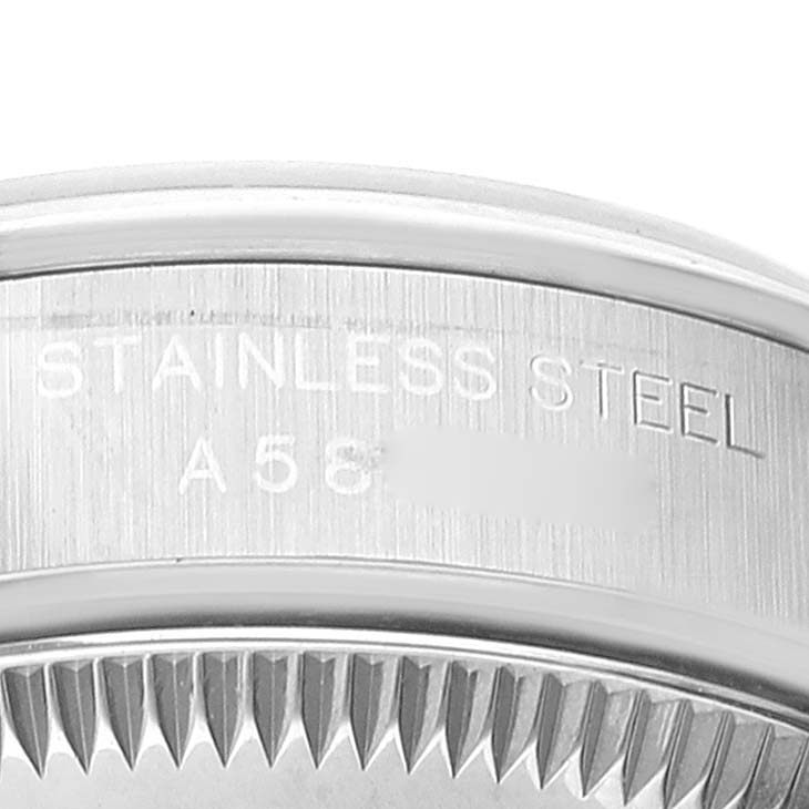 The image shows a close-up side view of the case back of a Rolex Oyster Perpetual 76080 Women's Stainless Steel Blue Dial 76080 Women's Stainless Steel Blue Dial watch, highlighting the stainless steel material and part of the serrated edge.