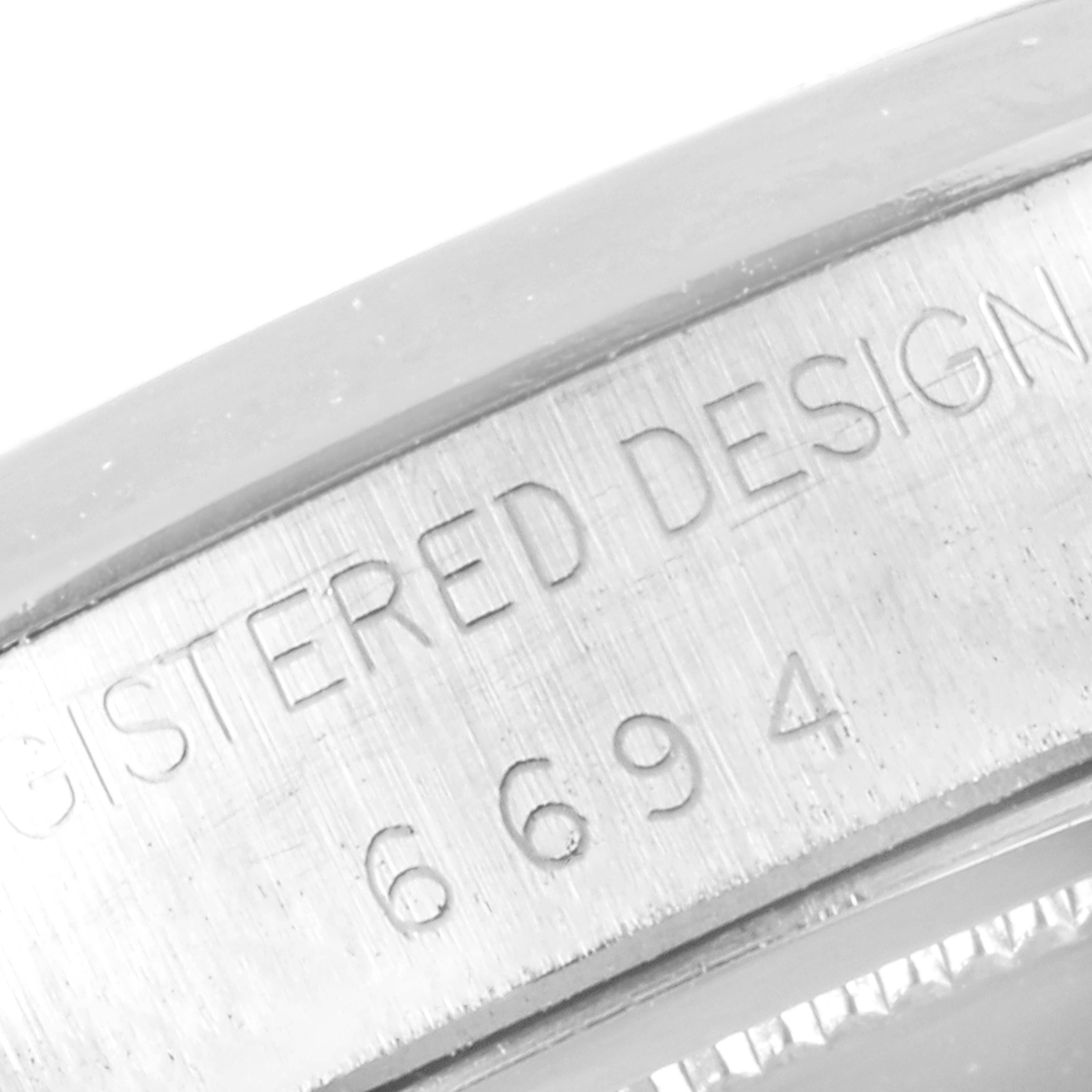 This image shows a close-up of the engraved bezel on a Rolex Vintage Collection 6694 Men
s Stainless Steel Silver Dial 6694 Men
s Stainless Steel Silver Dial model watch.