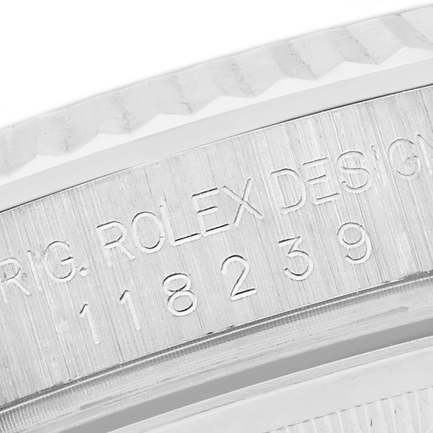 The image shows a close-up of the engraved bezel and case of a Rolex President 118239 Men's White Gold Pink Dial 118239 Men's White Gold Pink Dial model watch.