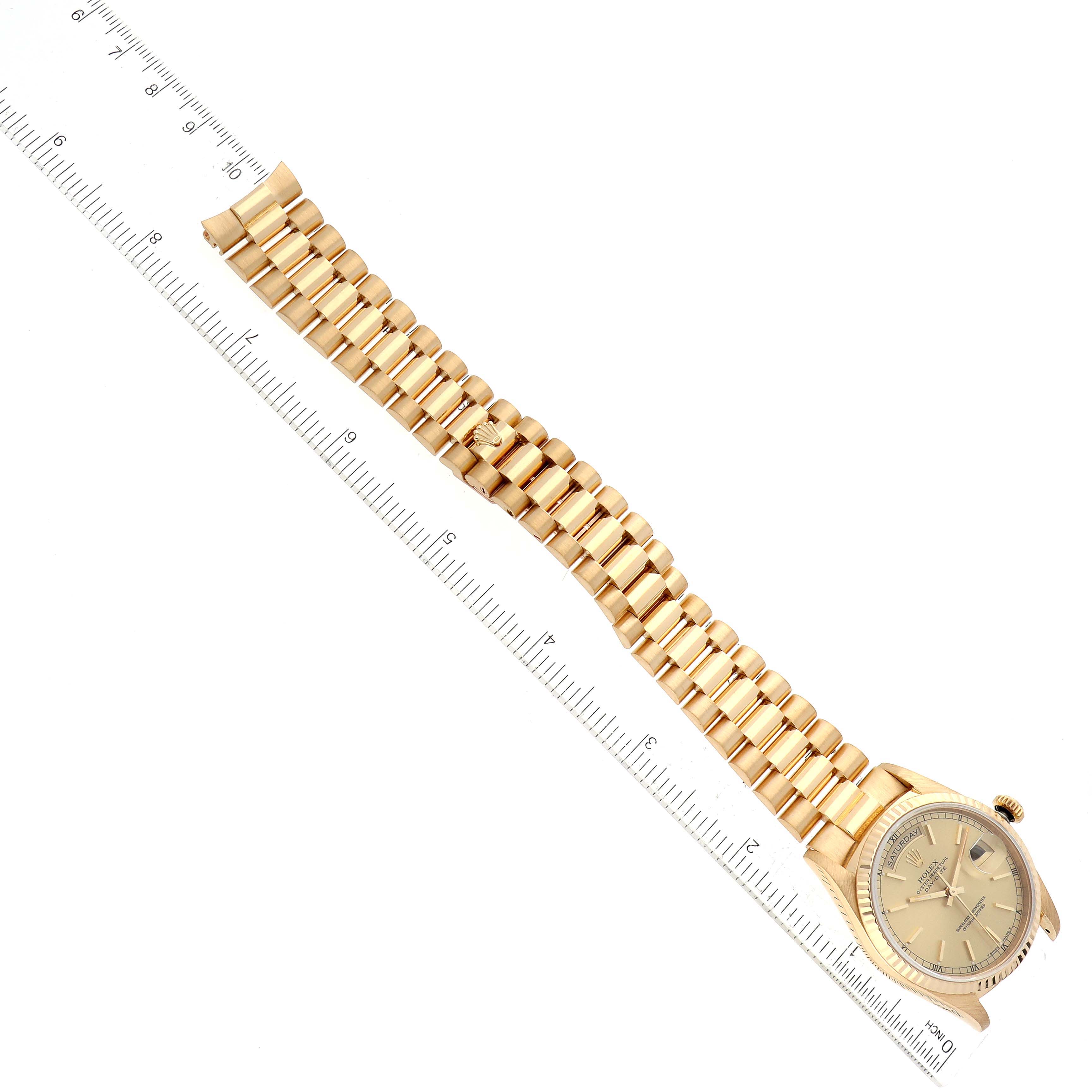 The image shows a Rolex President 18238 Men's Yellow Gold Champagne Dial 18238 Men's Yellow Gold Champagne Dial model watch, viewed from above, with the entire gold bracelet and face visible next to a ruler.