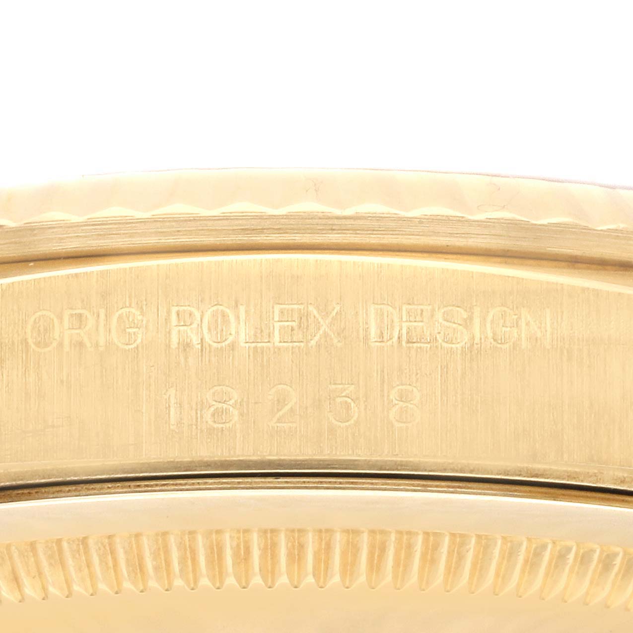 A close-up angle of the side of the Rolex President 18238 Men's Yellow Gold Champagne Dial 18238 Men's Yellow Gold Champagne Dial model watch showing the engraved serial and model numbers.