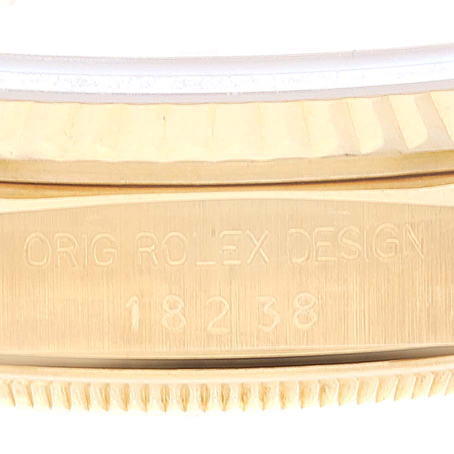 The image shows a close-up of the side engraving on the Rolex President 18238 Men's Yellow Gold Beige Dial 18238 Men's Yellow Gold Beige Dial model 18238, focusing on the serial number and branding.