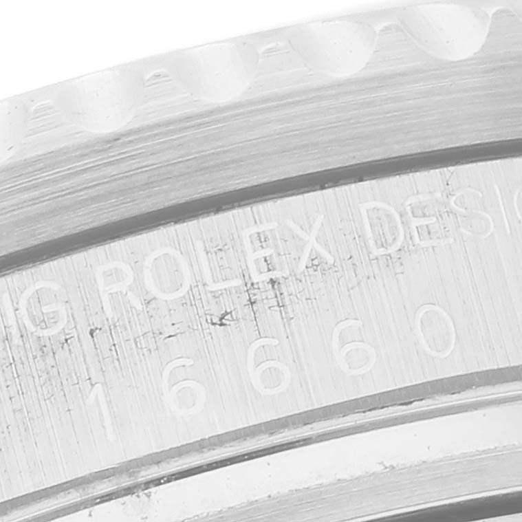 This close-up image shows the engraved text on the bezel and case back of a Vintage Collection Rolex watch.